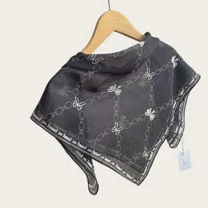 Detail showing the lightweight breathable cotton fabric with white chain and bow pattern.