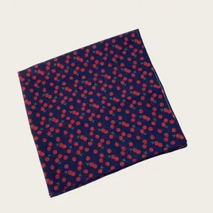 Detailed close-up view of navy blue cotton linen scarf with red tomato print pattern