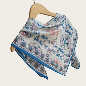 Detailed macro shot of a lightweight Chinese style floral cotton square scarf with blue borders