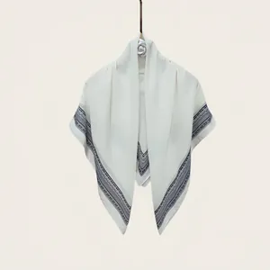 Elegant silk-cotton square scarf featuring intricate navy blue geometric border patterns
