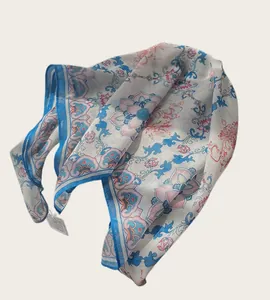 Detail shot of a lightweight Chinese style floral cotton square scarf for women.