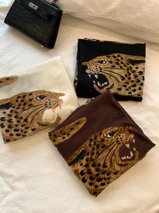Detalle de chales vintage con estampado de leopardo en blanco, negro y marrón para dama
