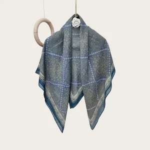 Elegant silk-cotton blend square scarf with paisley pattern on hanging display