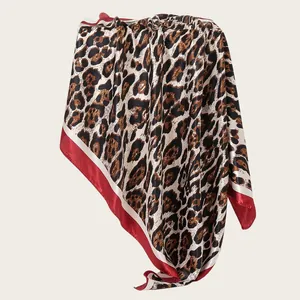 Detail view of 90cm leopard print satin scarf with red border contrast