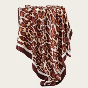 Close-up detail of the luxury leopard print satin square scarf showing fabric texture