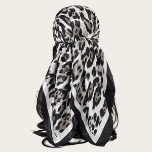 Detailed view of a 90cm leopard print satin square scarf showing smooth texture and drape