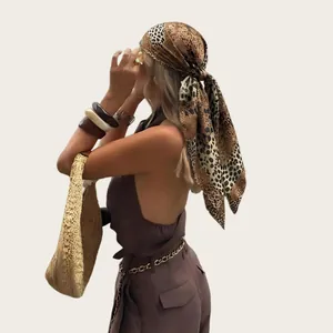 Stylish 90cm leopard print satin square scarf worn as a chic bohemian head wrap.