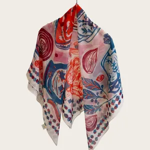 Close-up of the vibrant abstract print and lightweight fabric of a silk cotton square scarf