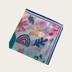 Macro view of silky scarf featuring vibrant rainbow, coral, and seashell print patterns