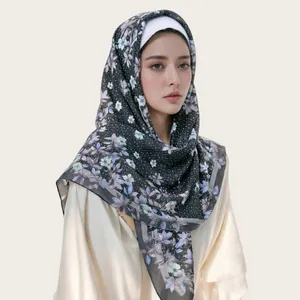 Detail view of floral print bali yarn square scarf with wavy edges on model