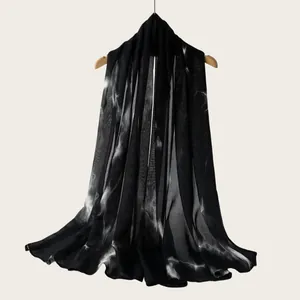 Elegant black viscose scarf detail with white watercolor gradient stripe pattern.
