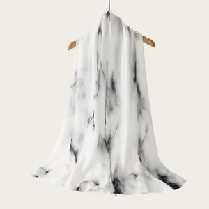 Detailed macro view of white rayon scarf with black watercolor ink wash pattern.