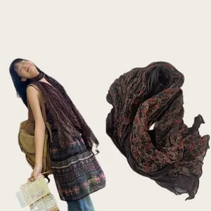 Detail of vintage floral cotton linen wrinkled scarf with soft texture for travel styling.