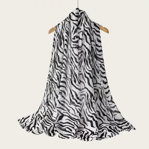 Black and white zebra print rayon scarf hanging on a wooden hanger