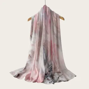 Detail showing the soft drape and watercolor gradient pattern of the rayon scarf.