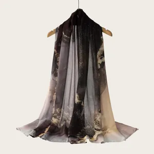 Detail view of a long scarf with elegant watercolor gradient stripes and soft texture.