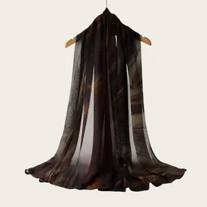 Detailed view of rayon scarf with brown watercolor gradient stripes on a hanger