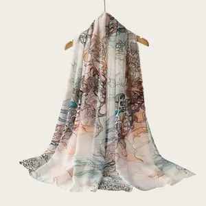 Detailed view of lightweight watercolor gradient scarf draped on wooden hanger