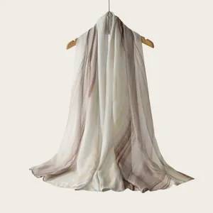 Detailed view of long rayon scarf featuring watercolor gradient stripes and earthy tones