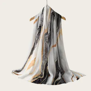 Detailed close-up of a premium rayon scarf with artistic gold and grey watercolor stripes