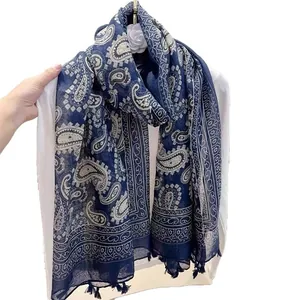 Detail of lightweight navy blue paisley print scarf with decorative fringe accents