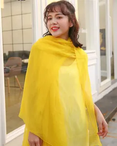 Model wearing a vibrant yellow oversized sun protection lightweight shawl scarf