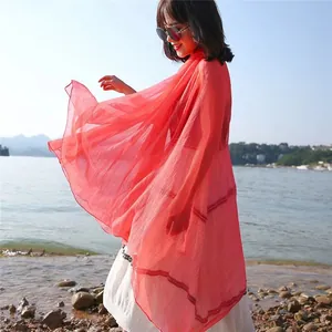 Elegant red chiffon sun protection shawl for women, lakeside lifestyle detail shot