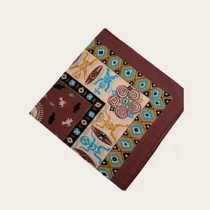 Close-up detail of geometric tribal print silk scarf with brown and blue patterns