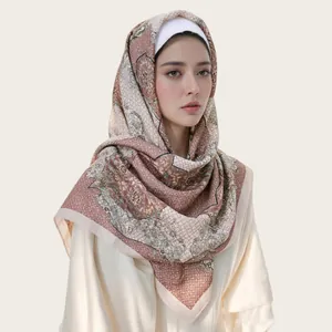 Elegant floral print square voile hijab scarf worn by a model in a professional studio