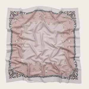 Close-up detail of floral print square hijab with scalloped borders and textured patterns