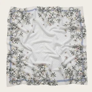 Close-up detail of lightweight Bali yarn square scarf featuring elegant floral print patterns