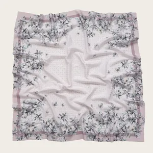 Detailed view of floral print square voile hijab scarf featuring wavy laser-cut edges