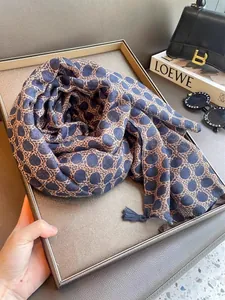 Detailed view of an ethnic style printed scarf with leopard dot pattern and tassels.