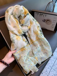 Detailed view of a yellow floral ethnic style shawl with elegant yellow tassel fringe.