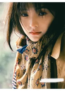 Detailed macro view of a vintage floral patterned silk shawl draped over a woman's shoulders