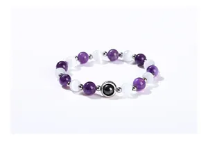 Close-up of natural amethyst and white gemstone beaded bracelet on white background