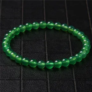 Close-up of 6mm green cat's eye stone beaded bracelet with glossy finish