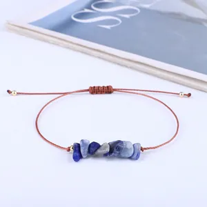 Detailed view of bohemian handmade wax thread bracelet with irregular blue natural stones