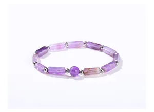 Close-up of a natural purple amethyst bracelet with faceted rectangular beads and silver spacers.