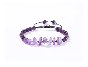 Detailed view of natural amethyst bracelet with irregular beads on black woven cord