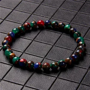 Macro detail view of 6mm multi-colored stone beads bracelet with polished texture finish.