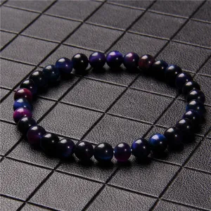 Detailed close-up of 6mm blue and purple cat's eye stone beaded bracelet on black grid