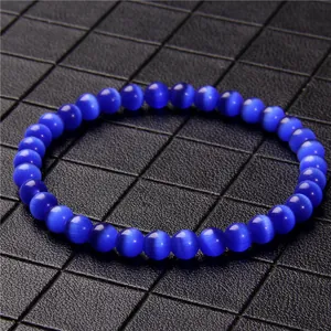 Macro shot of 6mm blue cat eye stone beaded bracelet with shimmering chatoyancy
