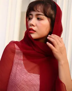 Close-up view of an elegant wine red textured chiffon scarf worn gracefully as a headscarf