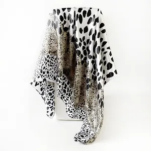 Detailed view of the leopard print satin square scarf showing its elegant silky texture