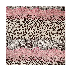 Detail shot of the vibrant pink and brown leopard print on a satin square scarf