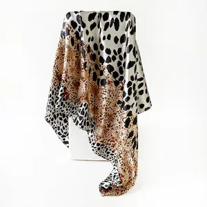 Close-up detail of luxury satin leopard print square scarf with elegant silky finish