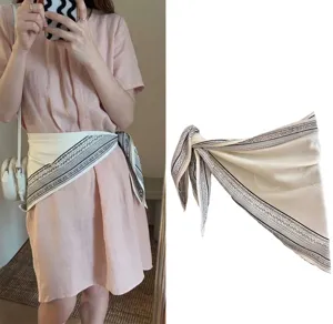 Detailed view of vintage cashew flower triangle silk scarf worn as a waist belt