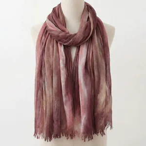Detail view of a vintage folk style gradient pleated long scarf with frayed edges