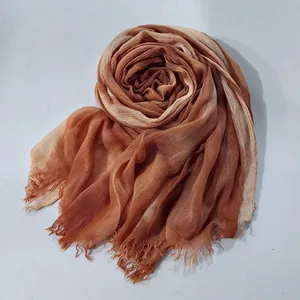 Detailed view of brown gradient crinkled scarf with fringe edges and ethnic style